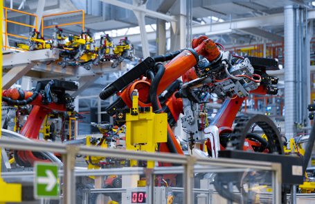 Engineer testing a robotic production simulator in robotics research facility